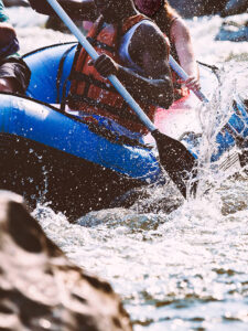 kayaking in whitewater with safety gear